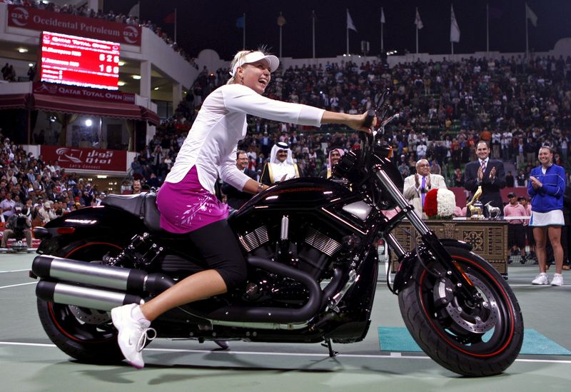 © Reuters. File photo of Russia's Maria Sharapova on a motorcycle at the Qatar Open tennis tournament in Doha