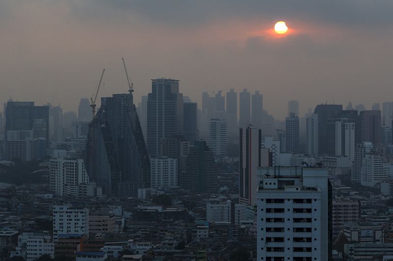 © Reuters. A partial solar eclipse is seen through clouds in Bangkok