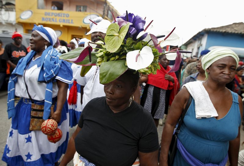 © Reuters. Supporters of slain environmental rights activist Berta Caceres walk along a street during her funeral in the town of La Esperanza, outside Tegucigalpa