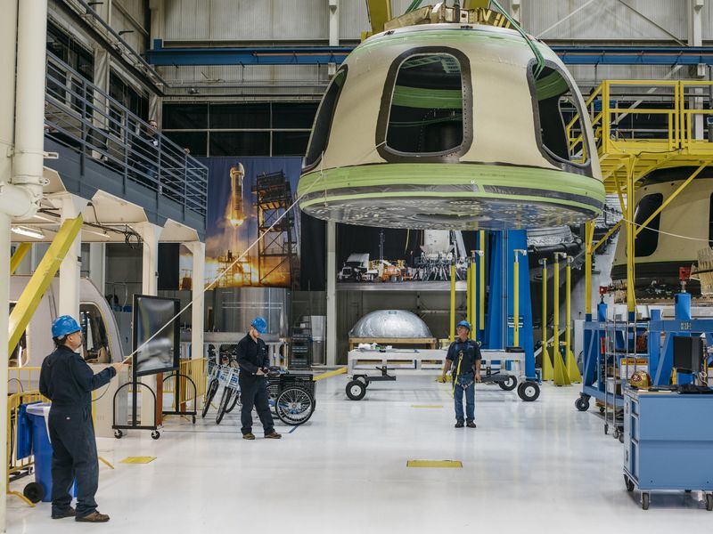 © Reuters. Handout Blue Origin photo shows Blue Origin team members ready the New Shepard Crew Capsule during assembly in Kent, Washington