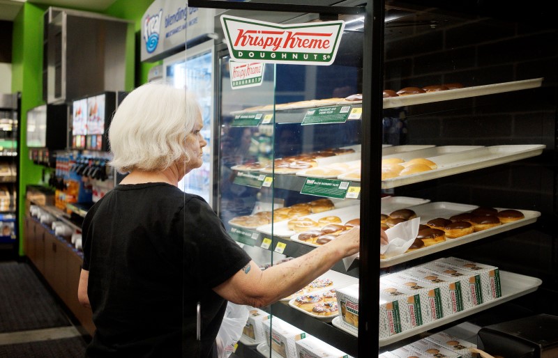 © Reuters. Customer buys Krispy Kreme doughnuts Walmart to Go test convenience store in Bentonville