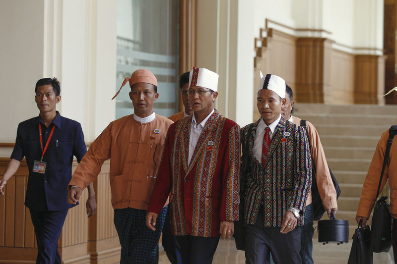 © Reuters. Henry Van Hti Yu, the National League for Democracy  nominated presidential candidate for the upper house of parliament, leaves parliament in Naypyitaw