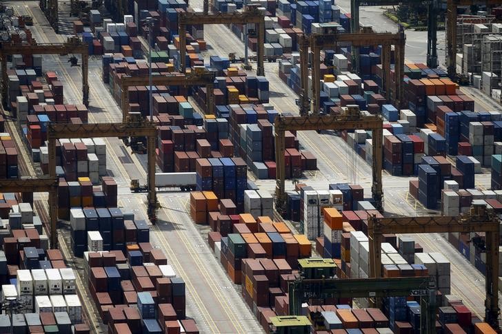 © Reuters. A truck passes containers at PSA's Tanjong Pagar container terminal in Singapore