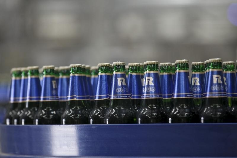 © Reuters. Bottles of beer are seen on an assembly line during the opening ceremony of the Heineken Beer factory outside Yangon 