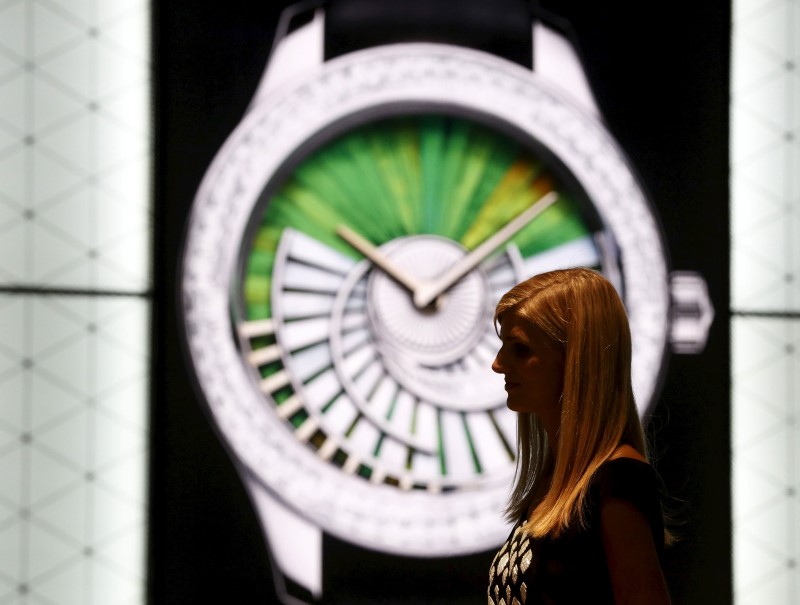 © Reuters. A staff of Baselworld stands in front of the Dior showroom at the Baselworld watch and jewellery fair in Basel