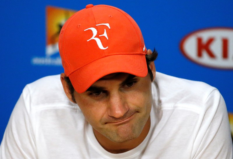 © Reuters. Switzerland's Federer reacts during a news conference after losing his semi-final match against Serbia's Djokovic at the Australian Open tennis tournament at Melbourne Park