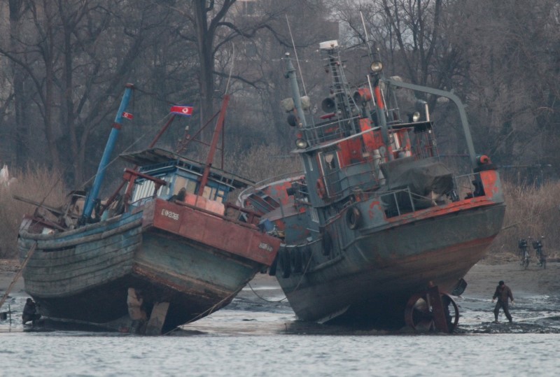 © Reuters. A cargo boat is seen on the bank of the Yalu River in Sinuiju