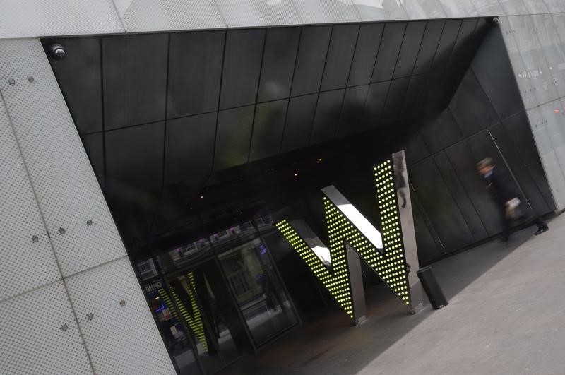 © Reuters. A man walks into the 'W London' hotel in Leicester Square in central London