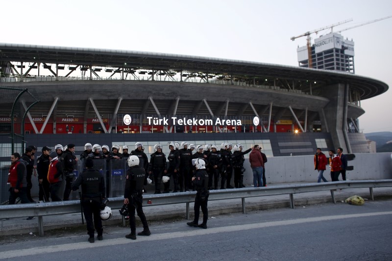 © Reuters. Riot police stand guard as Galatasaray soccer fans leave from the Turk Telekom Arena in Istanbul