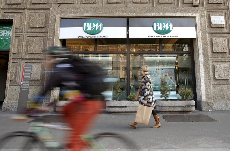 © Reuters. File photo of a woman walking in front of the Banca Popolare di Milano (BPM) bank in downtown Milan