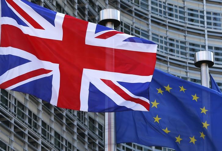 © Reuters. A Union Jack flag flutters next to European Union flags ahead of a visit from Britain's PM Cameron at the EU Commission headquarters in Brussels