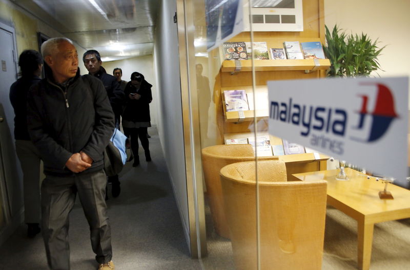 © Reuters. Family members of passengers onboard Malaysia Airlines flight MH370 which went missing in 2014, leave its Beijing office after their gathering on the second anniversary of the disappearance of MH370, in Beijing