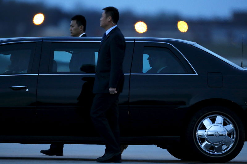 © Reuters. Security agents walk alongside Xi's car as he arrives to attend the upcoming Nuclear Security Summit meetings in Washington, on the tarmac at Joint Base Andrews, Maryland