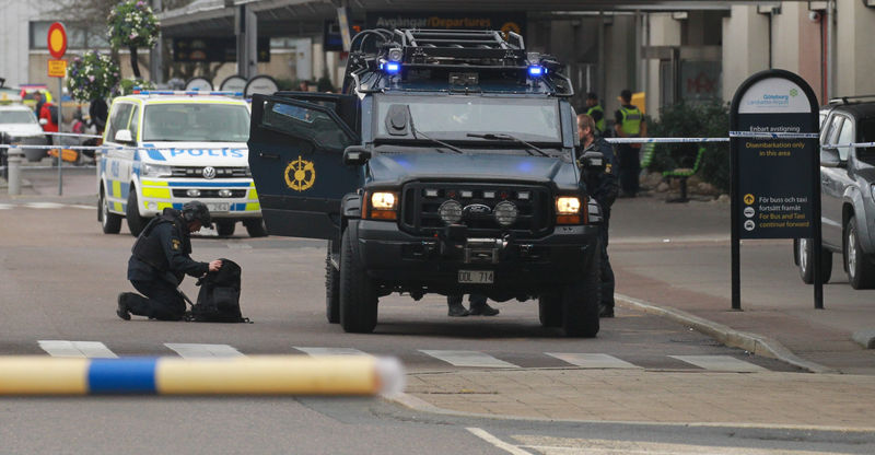 © Reuters. The police bomb squad works outside the cornered off domestic flight terminal at Landvetter Airport near Gothenburg