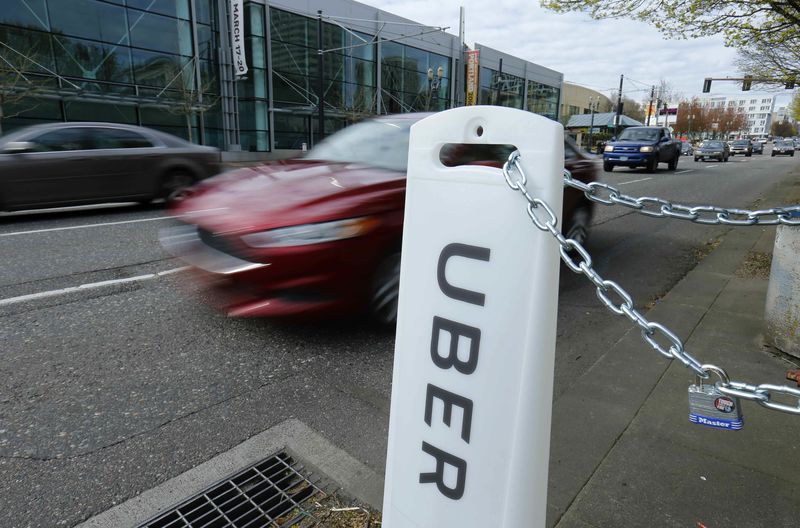 © Reuters. Uber sign points to drop off and pick up location in Portland
