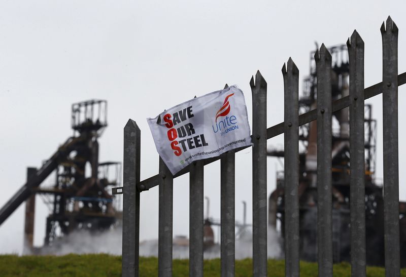 © Reuters. File photograph shows union banner hanging from a fence in front of the Tata steelworks in the town of Port Talbot