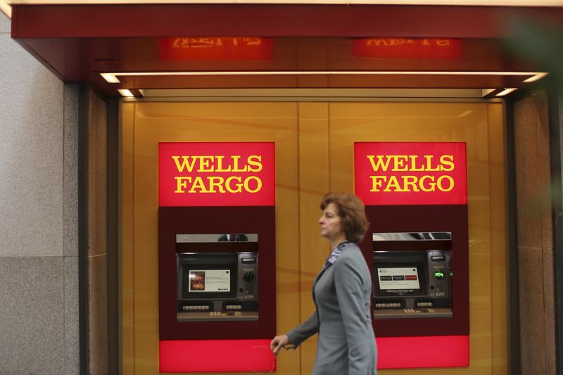 © Reuters. File photo of a woman walking past teller machines at a Wells Fargo bank in San Francisco