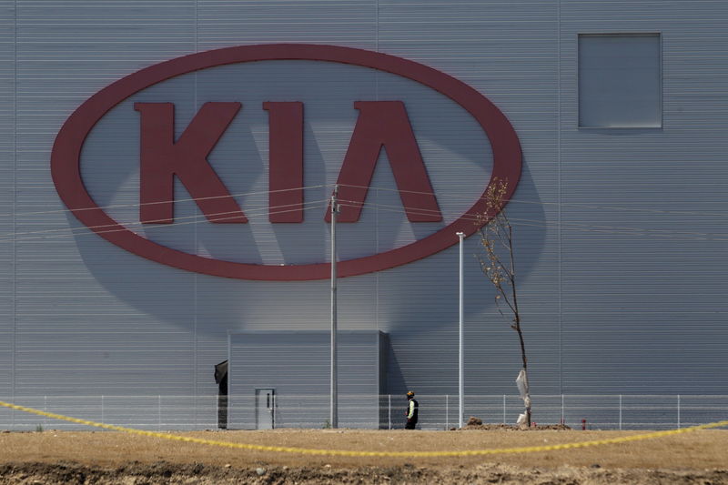 © Reuters. Man walks past the logo of Kia Motors at the manufacturing plant in Pesqueria