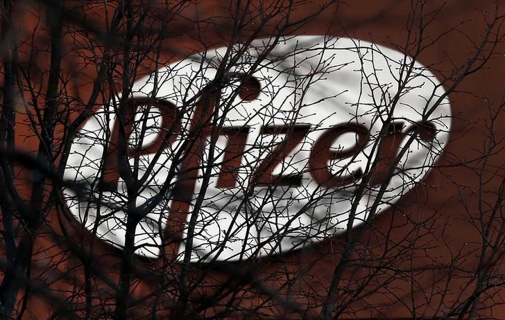 © Reuters. A company logo is seen through branches at a Pfizer office in Dublin