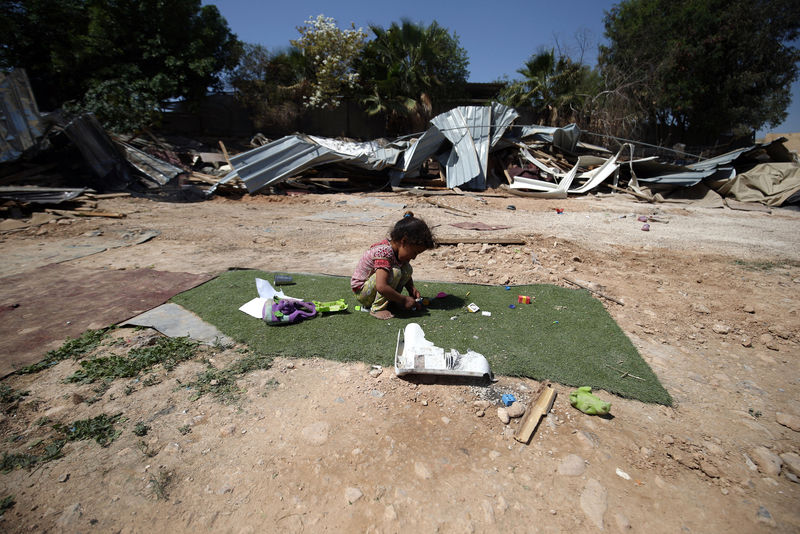 © Reuters. Palestinian girl plays outside her family structure after it was demolished by Israeli forces near the West Bank city of Jericho 