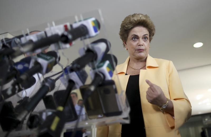 © Reuters. President Rousseff addresses a news conference after visiting the new Embraer KC 390 military transport aircraft in Brasilia