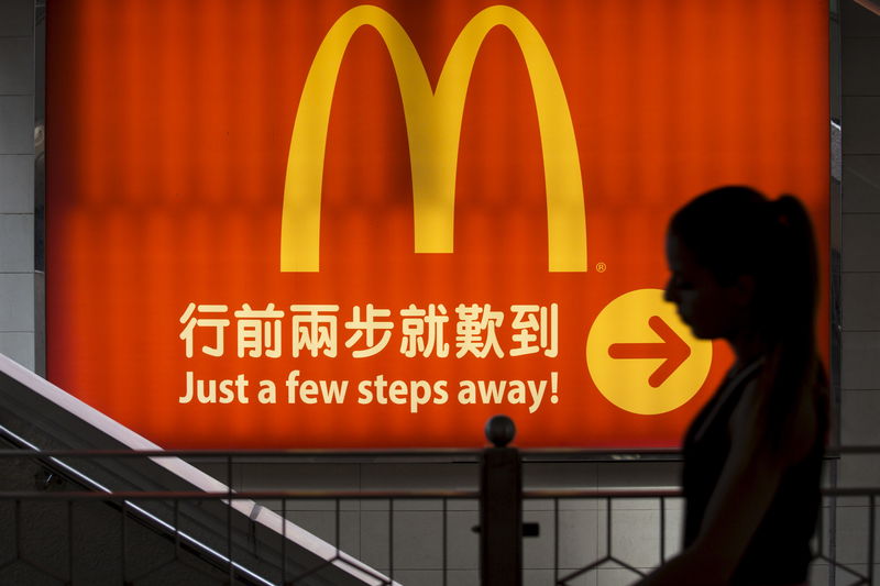 © Reuters. File photo of a woman walking past a McDonald's outlet in Hong Kong