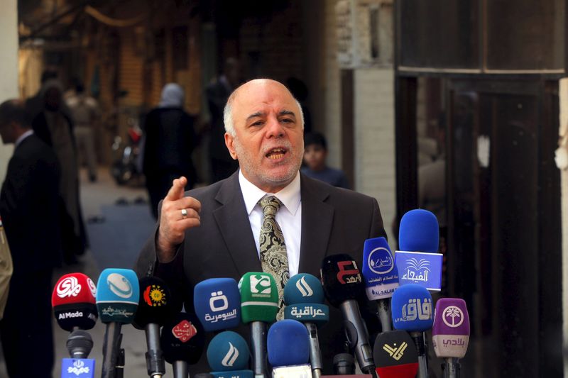 © Reuters. File photo of Iraqi PM Haider al-Abadi at news conference during visit to Najaf, south of Baghdad