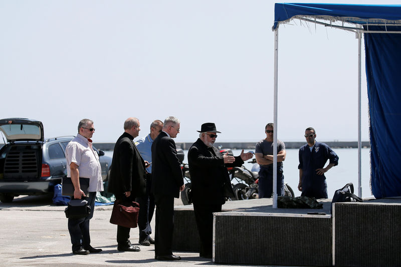 © Reuters. Catholic Archbishop of the Greek islands of Naxos, Tinos and Mykonos, Nikolaos oversees preparations for a ceremony at the port, at the city of Mytilene on the Greek island of Lesbos