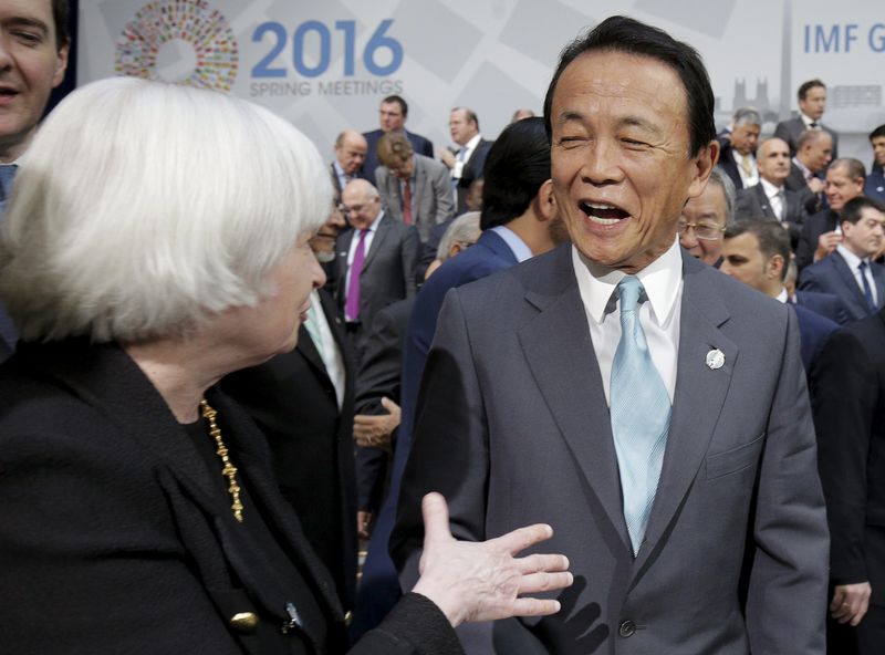 © Reuters. U.S. Federal Reserve Board Chair Janet Yellen speaks with Japanese Finance Minister Taro Aso after the International Monetary and Financial Committee family photo during the 2016 World Bank-IMF Spring Meeting in Washington