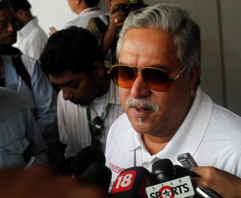 © Reuters. Force India team principal Vijay Mallya talks to the media in the paddock during the third practice session of the Indian F1 Grand Prix at the Buddh International Circuit in Greater Noida