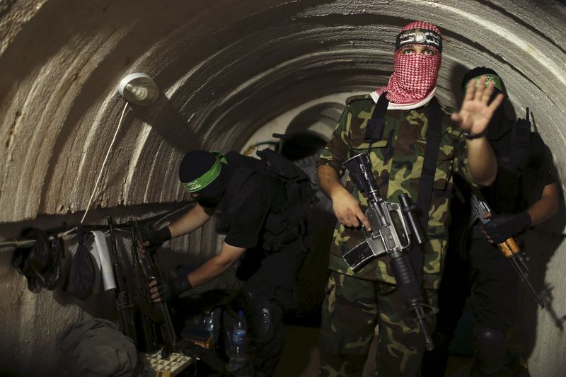 © Reuters. File photo shows a Palestinian fighter from the Izz el-Deen al-Qassam Brigades, the armed wing of the Hamas movement, gesturing inside an underground tunnel in Gaza