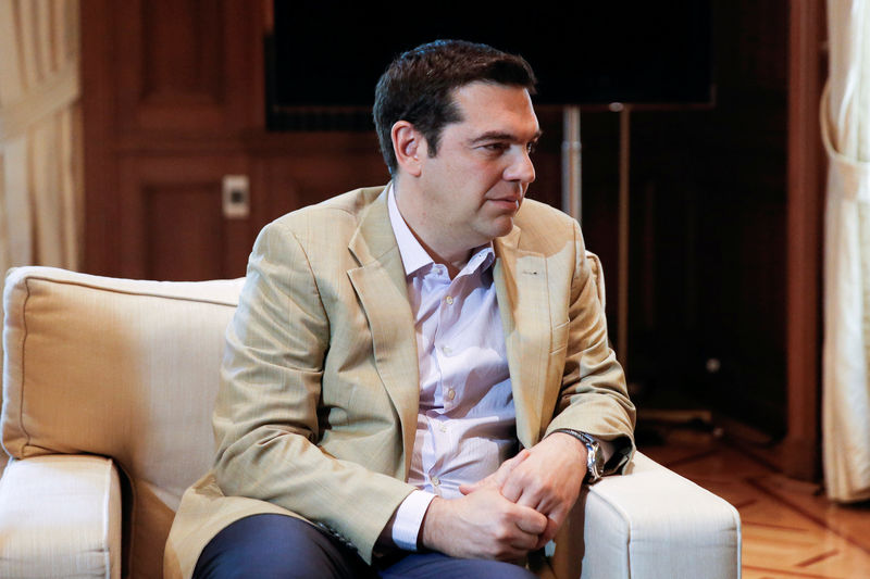 © Reuters. Greek PM Tsipras looks on as he meets with European Commission Vice-President Katainen in his office in the Maximos Mansion in Athens