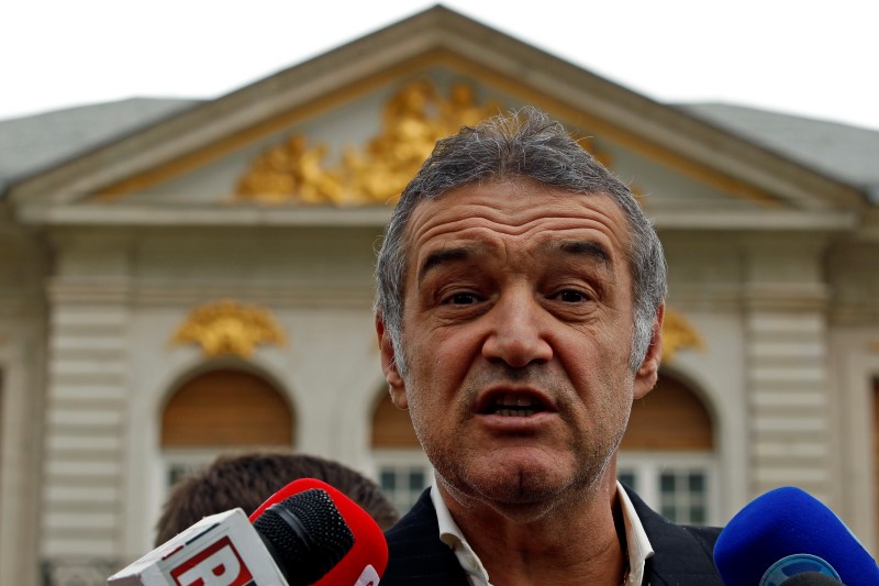 © Reuters. Romanian lawmaker and soccer club owner George Becali  talks to the media in Bucharest