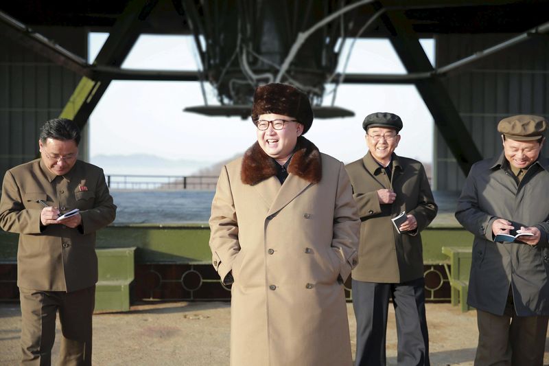 © Reuters. North Korea leader Kim Jong Un smiles as he visits Sohae Space Center for the testing of a new engine for an ICBM