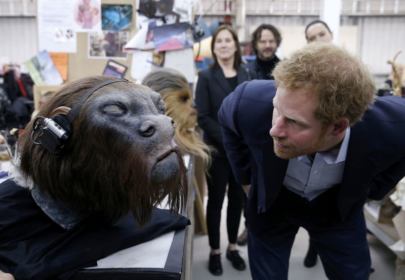 © Reuters. Britain's Prince Harry takes a closer look at a robotic mask during a tour of the Star Wars sets at Pinewood studios in Iver Heath, west of London