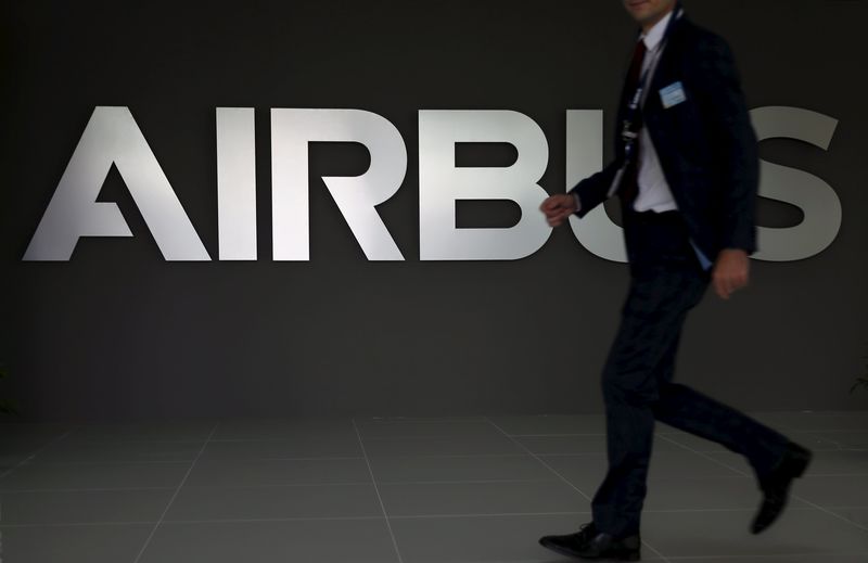 © Reuters. An employee passes an Airbus signage at the new Airbus Asia Training Centre in Singapore 