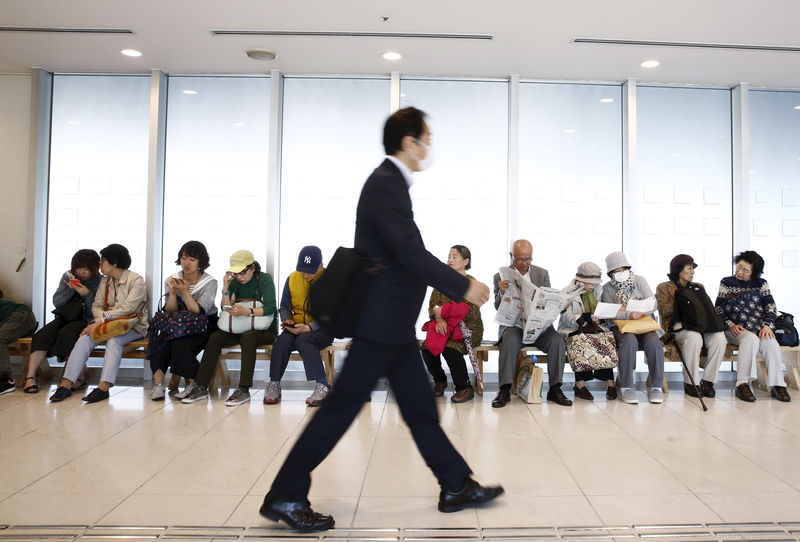 © Reuters. People sit in a shopping centre near Shinjuku station in Tokyo