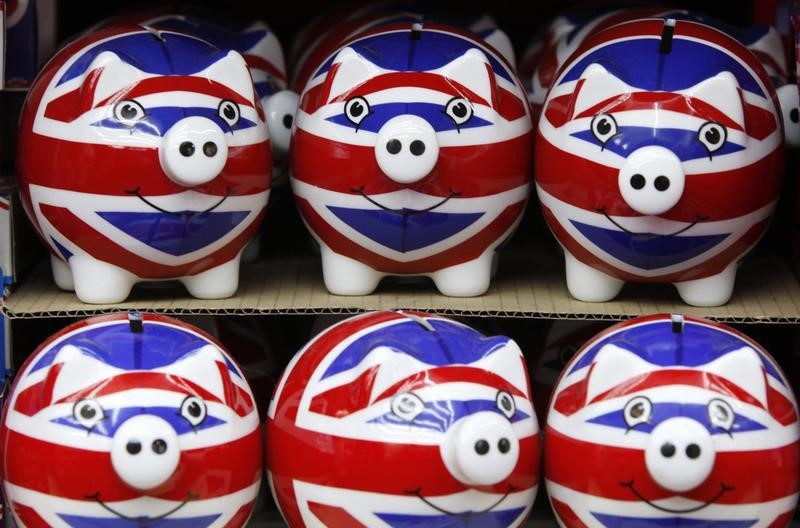 © Reuters. Row of piggy banks adorned with the colours of Britain's Union Jack flag are seen in a souvenir shop in London