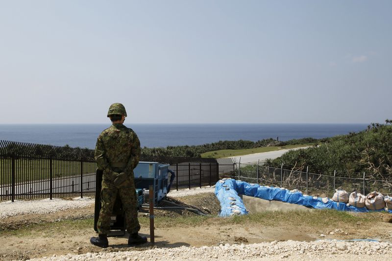 © Reuters. A soldier of Japan's Self Defence Force keeps watch at a newly opened military base on the island of Yonaguni