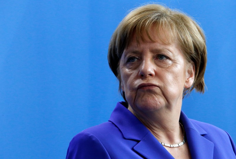 © Reuters. German Chancellor Merkel looks away during a statement to the media following talks with Lithuania's President Grybauskaite at the Chancellery in Berlin