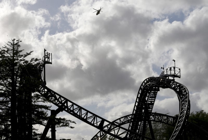 © Reuters. An ambulance flies over the Smiler ride at Alton Towers in Alton