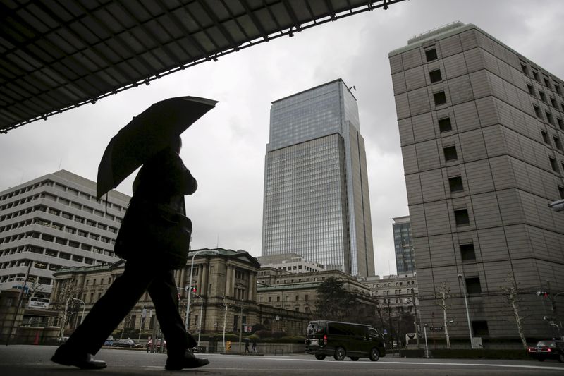 © Reuters. File photo of a businessman walking near Bank of Japan headquarters in Tokyo