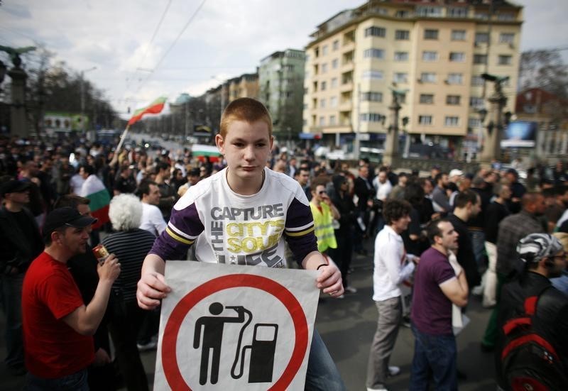 © Reuters. A protestor holds a poster during a blockade of the main boulevard in central Sofia