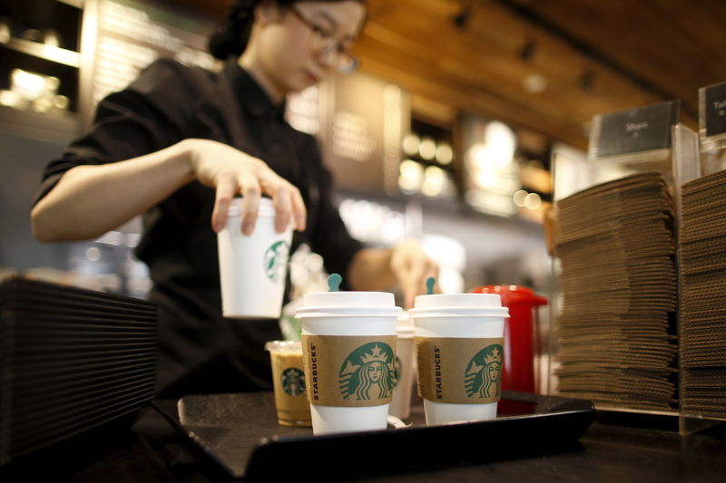 © Reuters. A staff serves beverages at a Starbucks coffee shop in Seoul