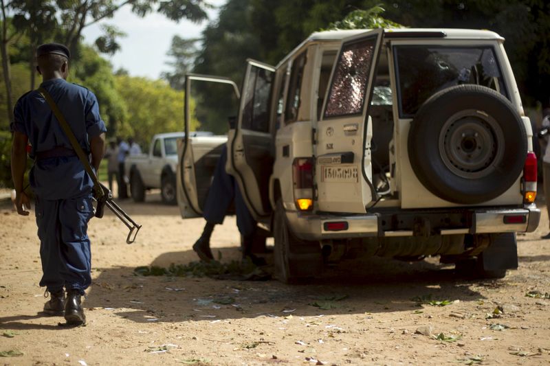 © Reuters. A policeman walks at the crime scene where Burundian General Kararuza was attacked and killed by unknown gunmen in Ntahangwa commune