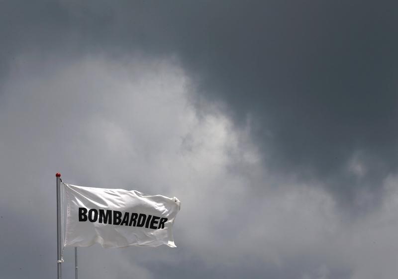 © Reuters. A Bombardier flag flutters amidst storm clouds at the Singapore Airshow at Changi Exhibition Center