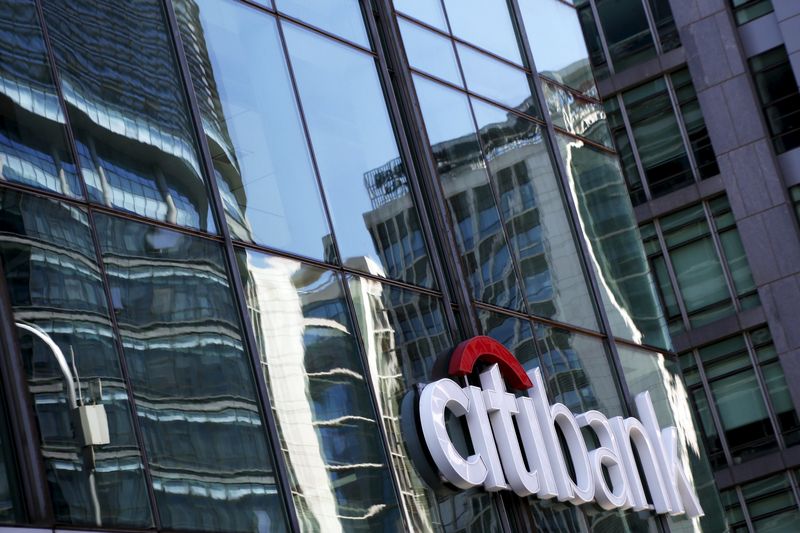 © Reuters. Reflections are seen on the glass facade of a Citibank branch in Beijing