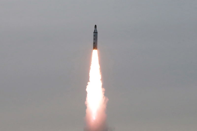 © Reuters. North Korean leader Kim Jong Un guides on the spot the underwater test-fire of strategic submarine ballistic missile