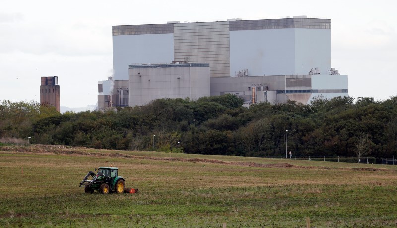 © Reuters. A tractor mows a field on the site where EDF Energy's Hinkley Point C nuclear power station will be constructed in Bridgwater, southwest England