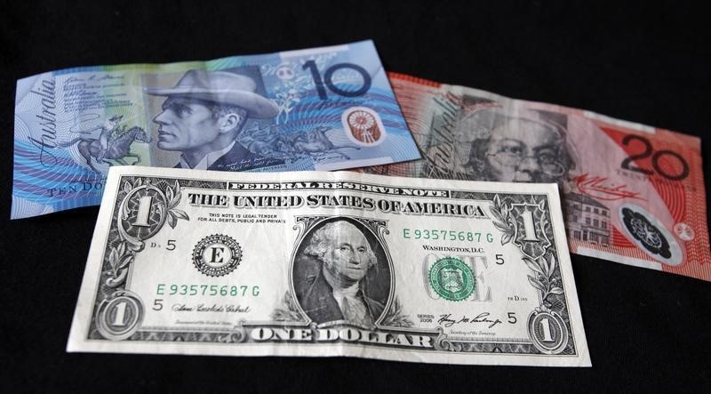 © Reuters. A US dollar note is pictured alongside Australian dollars in this picture illustration taken in Washington